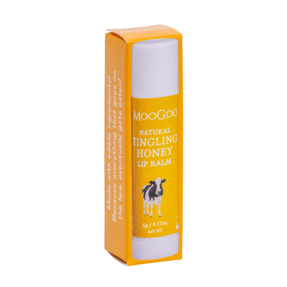 MooGoo Tingling Honey Lip Balm on plain background, petroleum-free balm with honey and menthol for lemony tingle, hydration and healing dry cracked lip