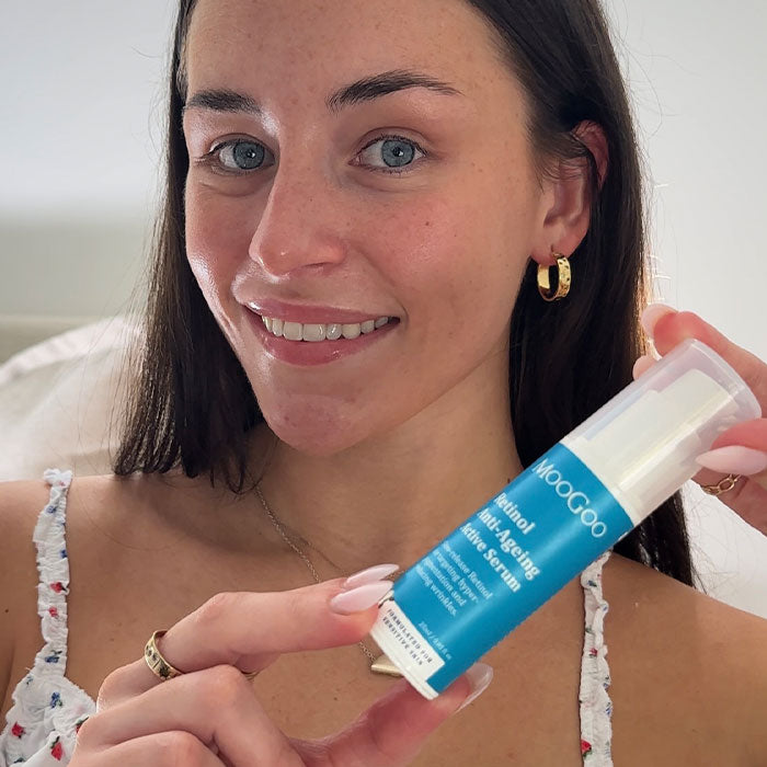 Young woman holding MooGoo Retinol Anti-Ageing Active Serum with the lid on - Vitamin A skincare for ageing, pigmentation, acne and texture concerns.