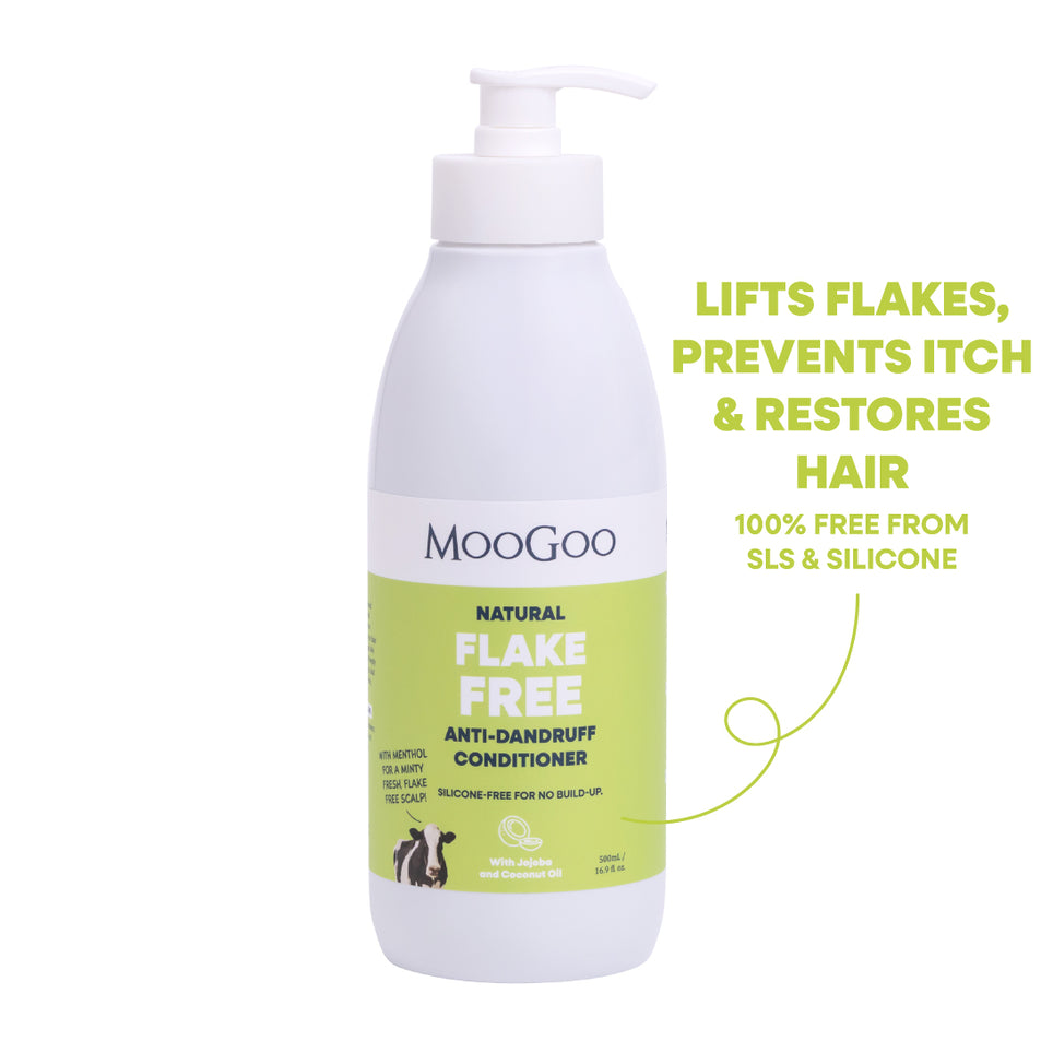 MooGoo Natural Flake Free Anti-Dandruff Conditioner in a white pump bottle with a light green label, shown on a white background with promotional text on the right. Silicone free formula with jojoba and coconut oil to restore dry scalp. 