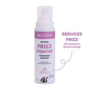 MooGoo Natural Frizz Fighter Hydrating Hair Mist in a white spray bottle with pink and black text, shown on a white background with a purple callout reading 'REDUCES FRIZZ DETANGLES & BOOSTS SHINE'. Silicone-free frizz spray with jojoba oil and pro vitamin B5. 