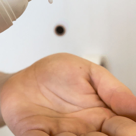 Woman applying MooGoo Ultra Hydrating Face Cream, lightweight daily cream with ceramides to strengthen skin barrier and improve hydration.