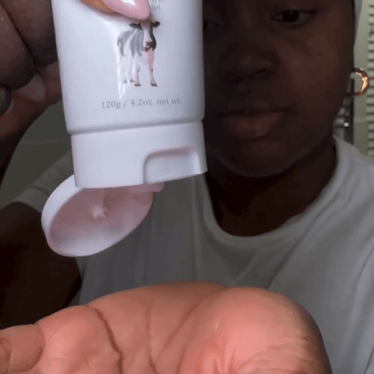 Woman applying MooGoo Skin Milk Udder Cream to face, natural restorative moisturiser with aloe vera and vitamin E for dry, sensitive or damaged skin.