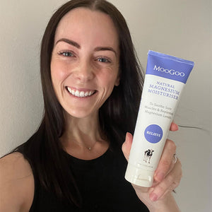 Woman holding MooGoo Natural Magnesium Moisturiser, hydrating cream for relaxation and recovery