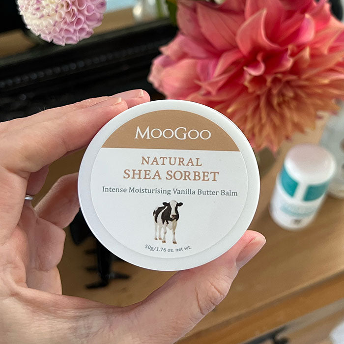 MooGoo Shea Sorbet Vanilla Butter Balm held in hand, natural skincare for chapped and cracked skin patches