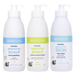 Three MooGoo Natural Sensitive Hair Care products on a white background: Natural Sensitive Scalp Milk Shampoo with a blue label, Natural Sensitive Scalp Cream Conditioner with a green label, and Natural Sensitive Skin Milk Wash with a light blue label.