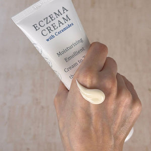 Eczema & Psoriasis Cream with Ceramides squeezed onto hand. Soothing and moisturising emollient to relieve dry, red itchy skin, PH balancing formula, Dermatologically tested.