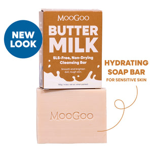 MooGoo Butter Milk SLS-Free Non-Drying Cleansing Bar shown with its brown cardboard box and the pale peach soap bar stacked below on a white background. Hydrating soap bar for dry skin, natural oils, SLS free and gentle on sensitive skin. 