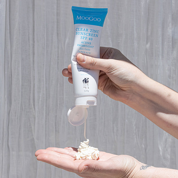 MooGoo Natural Sunscreen SPF 40 cream squeezed into hand, clear zinc oxide sunscreen with broad spectrum UVA & UVB protection
