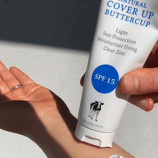 MooGoo Natural Cover Up Buttercup SPF 15 being applied do forearm, light zinc sunscreen moisturiser for face and body, non greasy daily protection.