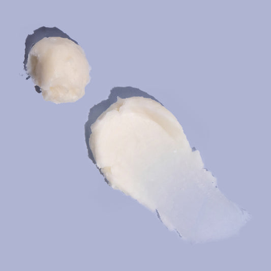 Natural Shea Sorbet Vanilla Butter Balm texture smear on purple background, thick balm for cracked hands and heels