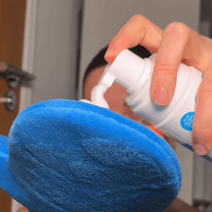 Woman applying MooGoo Tanning Mousse via MooGoo Tanning Mitt, natural bronzed finish with self tan mousse shown.