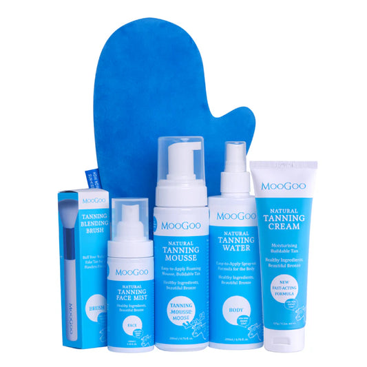 MooGoo Ultimate Tanning Bundle on plain background, includes tanning mousse, water, face mist and cream with blending brush and mitt for radiant skin