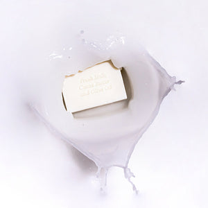 MooGoo Soothing Cleansing Bar Goat’s Milk in splash background, soothing goat’s milk bar with nourishing oils for sensitive or eczema-prone skin.